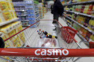 A customer stands in an aisle near a shopping trolley in a Casino supermarket in Nice